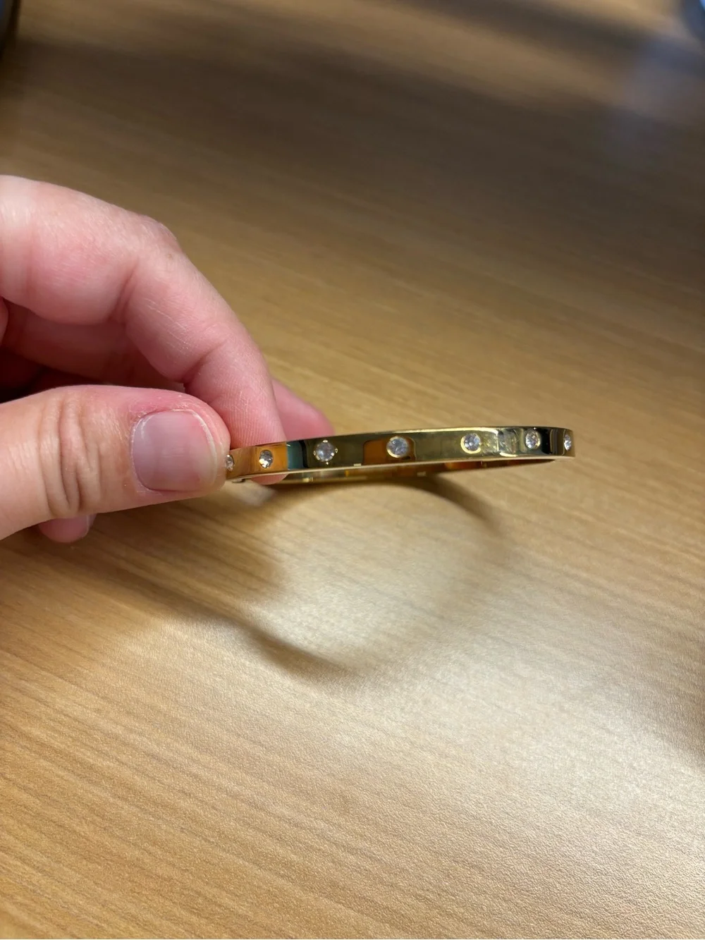 Kate Spade gold-tone hinged bangle featuring inset crystal accents
